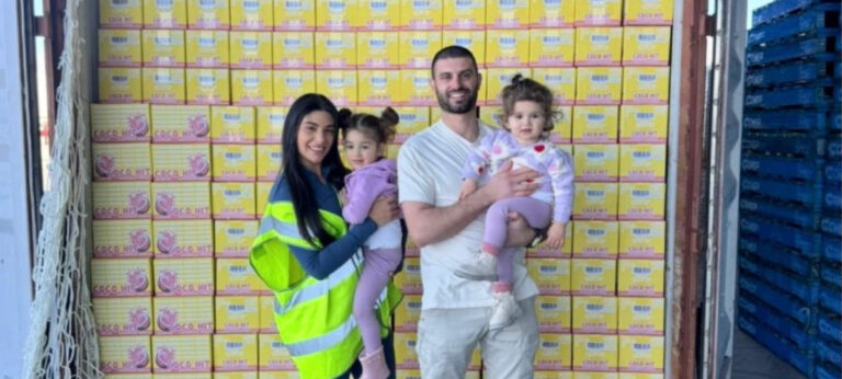 COCO HIT founders standing in front of stacked product cartons, supporting the announcement of the Melbourne startup’s new partnerships.