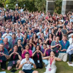 Argon & Co team group photo at an outdoor company event, with attendees wearing lanyards and posing together.