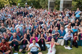 Argon & Co team group photo at an outdoor company event, with attendees wearing lanyards and posing together.