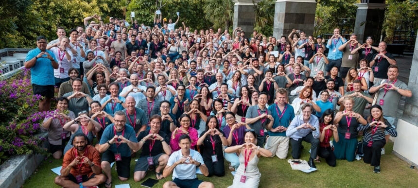 Argon & Co team group photo at an outdoor company event, with attendees wearing lanyards and posing together.