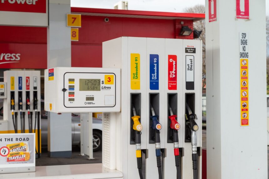 Close-up of fuel pumps at a service station, showing unleaded, premium unleaded and diesel nozzles alongside a digital fuel price display, illustrating fuel retail and energy infrastructure.