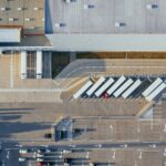 Aerial view of vehicles in parking area.