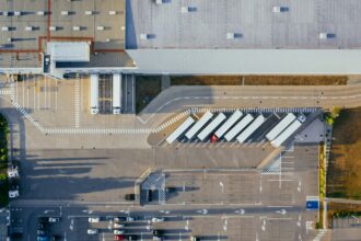 Aerial view of vehicles in parking area.