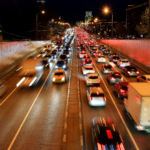 A busy highway road at night with orange hues.